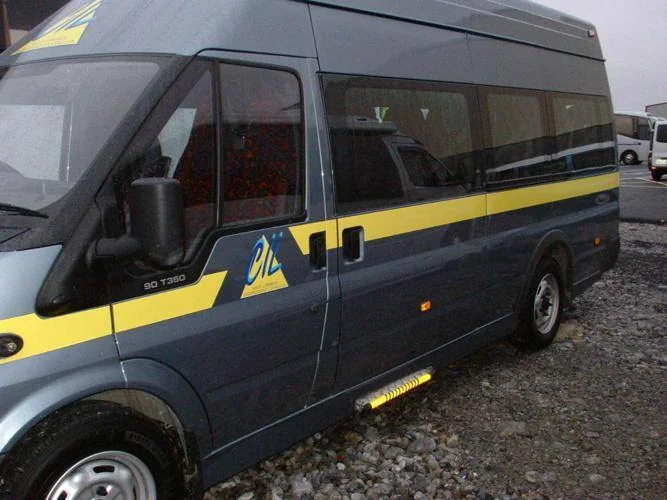 Older blue and yellow WLIL accessible minibus